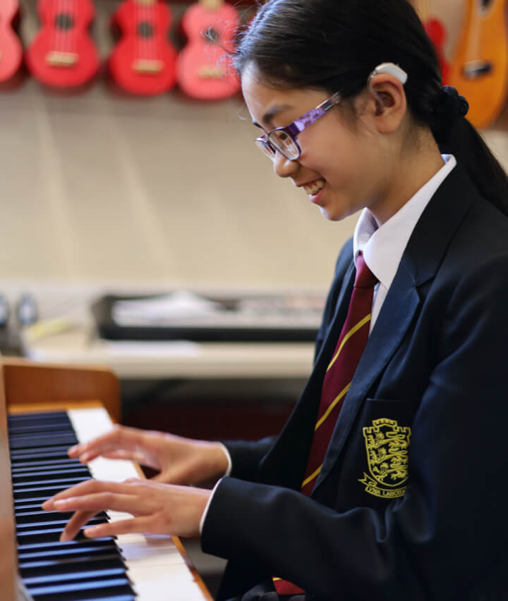 Kings student learning piano